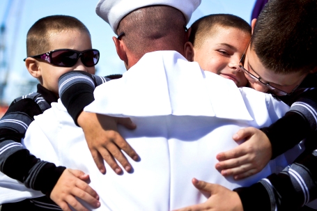 Engineman 1st Class Kevin Ives -- assigned to the guided-missile cruiser USS Princeton (CG 59) -- embraces his sons during a homecoming celebration at Naval Base San Diego. (U.S. Navy photo by Mass Communication Specialist 3rd Class Christopher Farrington)
